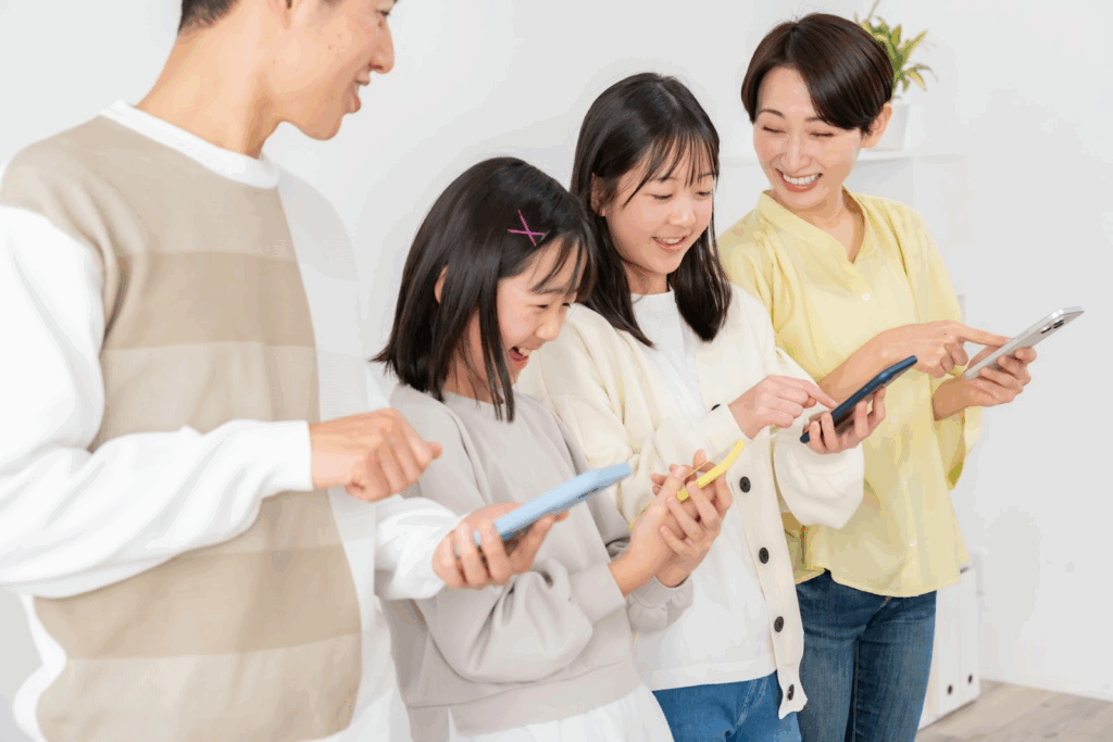 A family smiling and enjoying together while holding smartphones: States of Mind