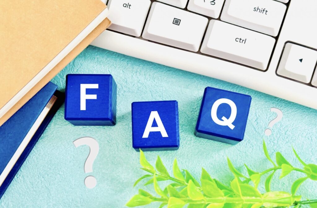 Blue blocks spelling "FAQ" placed next to a keyboard and notebook, decorated with question marks and green leaves. : diaphragmatic breathing