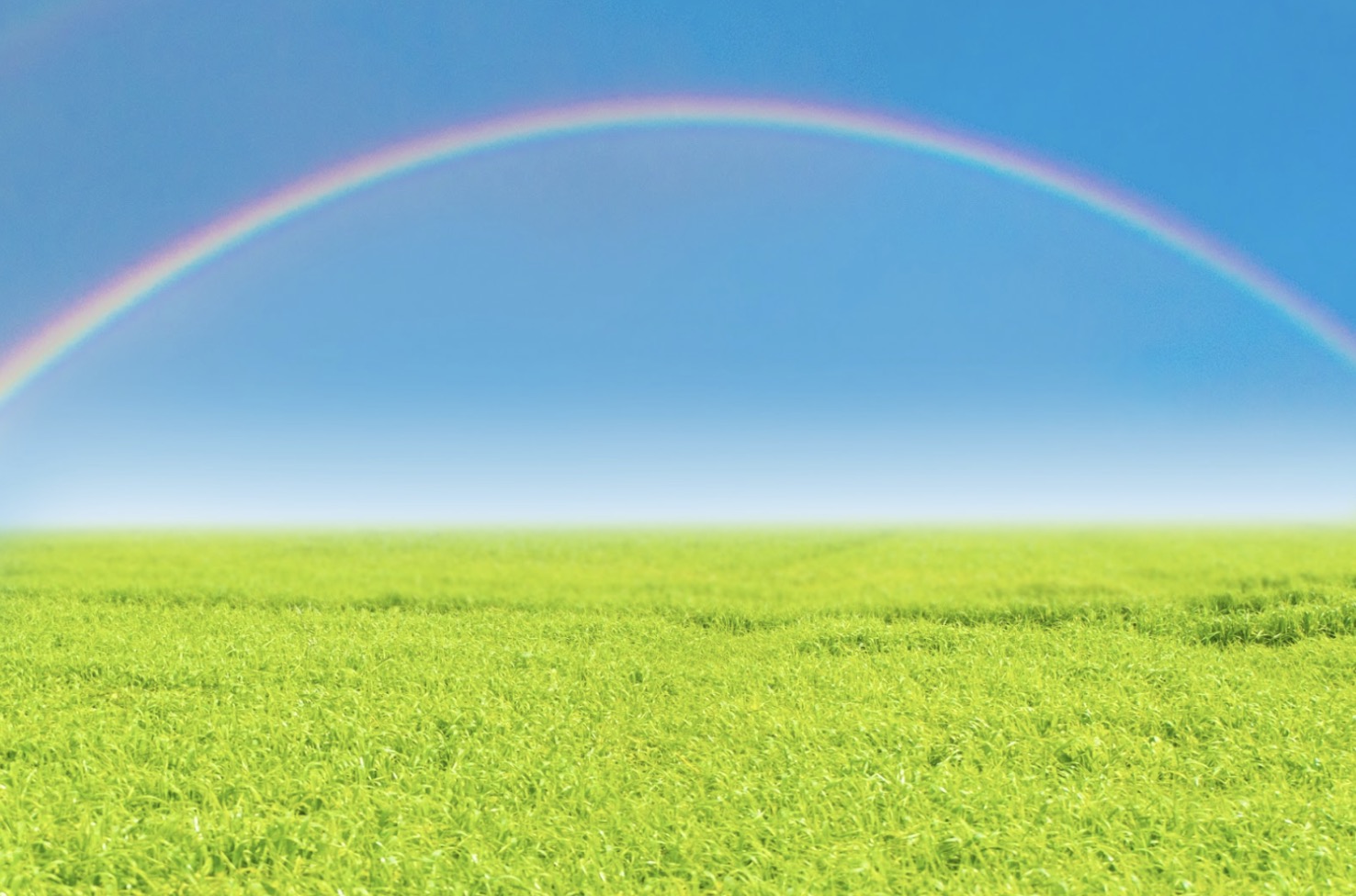 A large rainbow arching over a green meadow under a bright blue sky, creating a fresh and uplifting scene: Spiritual Retreat