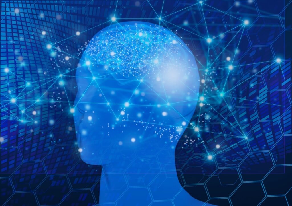 青い背景に描かれた人の横顔と脳のイメージ。脳内には光のネットワークやデジタルの線が広がり、人工知能や神経ネットワークの概念を表現している：リラックス法