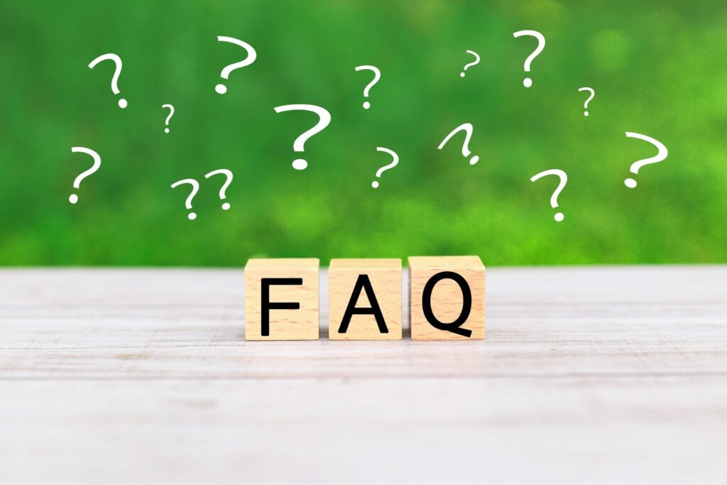 Wooden blocks spelling “FAQ” on a light wooden surface, with question marks floating above against a green background, symbolizing questions and answers: Spiritual Retreat